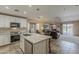 Open-concept kitchen with a central island and seamless transition to the adjacent living area at 29322 N Red Finch Dr, San Tan Valley, AZ 85143