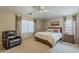 Spacious main bedroom with neutral tones, ceiling fan, carpeting, and custom window treatments at 29322 N Red Finch Dr, San Tan Valley, AZ 85143