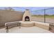 Inviting outdoor fireplace with a unique design and adjacent seating for cozy evenings at 29322 N Red Finch Dr, San Tan Valley, AZ 85143