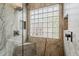 The shower features a marble wall and glass blocks for natural light at 29322 N Red Finch Dr, San Tan Valley, AZ 85143