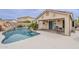 Stunning backyard pool with rock feature, landscaping, and covered patio area for relaxing at 29322 N Red Finch Dr, San Tan Valley, AZ 85143