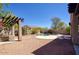 A beautiful backyard with desert landscaping, a swimming pool, and a built-in outdoor kitchen at 2982 E Boston St, Gilbert, AZ 85295