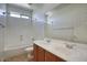 Bright bathroom features double sinks, tile flooring, and shower over tub at 2982 E Boston St, Gilbert, AZ 85295