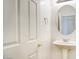 Bright bathroom featuring a pedestal sink, oval mirror and white door at 2982 E Boston St, Gilbert, AZ 85295