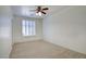 Bedroom featuring neutral carpet, bright natural light, and a ceiling fan at 2982 E Boston St, Gilbert, AZ 85295