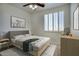 Nicely decorated bedroom with a ceiling fan, light walls, shuttered windows and nice décor at 2982 E Boston St, Gilbert, AZ 85295