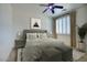 Brightly lit bedroom with stylish fan, white walls, shuttered windows and decorative bedspread at 2982 E Boston St, Gilbert, AZ 85295