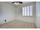 Well-lit bedroom features neutral carpet, ceiling fan and window with shutters at 2982 E Boston St, Gilbert, AZ 85295