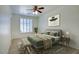 Stylish bedroom with a ceiling fan, white walls, window with shutters and a comfortable bed at 2982 E Boston St, Gilbert, AZ 85295
