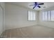 Bright bedroom features neutral carpet and windows with plantation shutters at 2982 E Boston St, Gilbert, AZ 85295