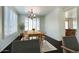 Airy dining room featuring dark wood floors, shutters on the windows, a wood table, and a chandelier at 2982 E Boston St, Gilbert, AZ 85295