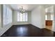 Dining room with dark hardwood floors, natural light, and modern chandelier at 2982 E Boston St, Gilbert, AZ 85295