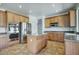 Eat-in kitchen with stainless steel appliances, an island with light countertops, and light wood cabinets and tile floors at 2982 E Boston St, Gilbert, AZ 85295