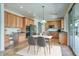 Spacious eat-in kitchen featuring wood cabinets, stainless steel appliances, tile floors, and a sliding glass door to a patio at 2982 E Boston St, Gilbert, AZ 85295