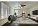 Bright living room with hardwood floors, ceiling fan, neutral decor, and white shutters and trim at 2982 E Boston St, Gilbert, AZ 85295