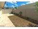 Backyard with paving stones, a dirt area, and a cinderblock fence with cacti at 3023 W Calavar Rd, Phoenix, AZ 85053