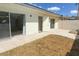 Backyard featuring a small dirt area, paving stones, and sliding glass doors to the house at 3023 W Calavar Rd, Phoenix, AZ 85053