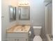 Bathroom with a toilet, framed mirror, sink, and shower at 3023 W Calavar Rd, Phoenix, AZ 85053