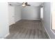 Spacious bedroom with light gray walls, plush carpeting, ceiling fan, and bright windows at 3023 W Calavar Rd, Phoenix, AZ 85053