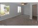 Bedroom with carpet, ceiling fan, and windows looking out to cacti at 3023 W Calavar Rd, Phoenix, AZ 85053