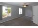Bedroom with carpet, ceiling fan, and windows looking out to cacti at 3023 W Calavar Rd, Phoenix, AZ 85053