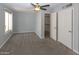 Neutral bedroom with a ceiling fan, carpet, and closet at 3023 W Calavar Rd, Phoenix, AZ 85053