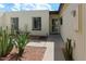 View of a charming home featuring a secure door, garden with cactus and desert landscaping at 3023 W Calavar Rd, Phoenix, AZ 85053