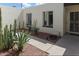 View of a charming home featuring a secure door, cactus and desert landscaping at 3023 W Calavar Rd, Phoenix, AZ 85053