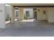 Cozy home featuring a covered parking area, secure door, cactus and desert landscaping at 3023 W Calavar Rd, Phoenix, AZ 85053