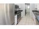 Eat-in kitchen featuring stainless steel appliances, laminate countertops, and neutral tile flooring at 3023 W Calavar Rd, Phoenix, AZ 85053