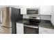 A modern kitchen featuring stainless steel appliances and ample countertop space at 3023 W Calavar Rd, Phoenix, AZ 85053
