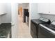 Bright laundry room featuring modern appliances and convenient access to the kitchen at 3023 W Calavar Rd, Phoenix, AZ 85053