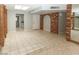 Living room featuring tiled floor and brick accents at 3023 W Calavar Rd, Phoenix, AZ 85053