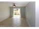 Bright living room with tile flooring and sliding glass doors to the backyard at 3023 W Calavar Rd, Phoenix, AZ 85053