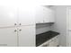 A well-organized pantry with white cabinets and drawers provides ample storage space at 3023 W Calavar Rd, Phoenix, AZ 85053