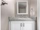 Bathroom vanity featuring white cabinets, granite countertop, and a framed mirror at 3030 N Hayden Rd # 16, Scottsdale, AZ 85251