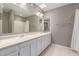Bathroom with double sink vanity, large mirror, and neutral color scheme at 3030 N Hayden Rd # 16, Scottsdale, AZ 85251