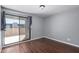 Bedroom featuring wood flooring and sliding glass door to the balcony at 3030 N Hayden Rd # 16, Scottsdale, AZ 85251