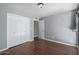 Bedroom featuring wood floors and a large closet at 3030 N Hayden Rd # 16, Scottsdale, AZ 85251
