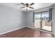 Bedroom with ceiling fan, dark wood floors and a glass door to balcony at 3030 N Hayden Rd # 16, Scottsdale, AZ 85251