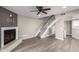 Spacious living room with fireplace, staircase, and wood flooring throughout at 3030 N Hayden Rd # 16, Scottsdale, AZ 85251