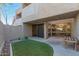 Charming patio with artificial turf, offers a relaxing outdoor space with views of the building's architectural details at 3030 N Hayden Rd # 16, Scottsdale, AZ 85251