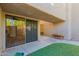 Private patio with artificial turf and seating, ideal for outdoor relaxation and entertaining, features backyard access at 3030 N Hayden Rd # 16, Scottsdale, AZ 85251