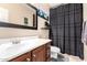 Bathroom featuring a stylish mirror, vanity with sink, toilet, and shower with curtain at 3343 E Ivanhoe St, Gilbert, AZ 85295