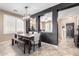 Elegant dining area with decorative lighting, natural light, and tile flooring at 3343 E Ivanhoe St, Gilbert, AZ 85295