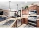 Stylish kitchen with stainless appliances, granite counters, and view to dining area at 3343 E Ivanhoe St, Gilbert, AZ 85295
