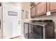 Functional laundry room with washer, dryer, cabinets, and a 'Thankful' door decor at 3343 E Ivanhoe St, Gilbert, AZ 85295