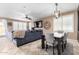 Open-concept living and dining space featuring a comfortable sofa, TV, and dining table at 3343 E Ivanhoe St, Gilbert, AZ 85295