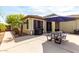 View of an open patio with a picnic table, grill, and desert landscaping at 3343 E Ivanhoe St, Gilbert, AZ 85295