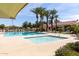 Community pool with palm trees and various seating options near the building at 3343 E Ivanhoe St, Gilbert, AZ 85295